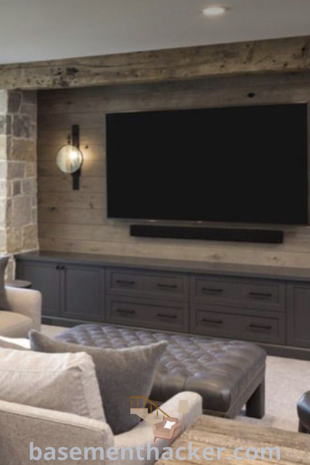 A living room featuring a rustic basement TV wall with multiple TVs, a built-in TV wall unit, and stylish furniture, ideal for a cozy and functional home. Discover more innovative basement makeover ideas for a stunning revamp at basementhacker.com.
