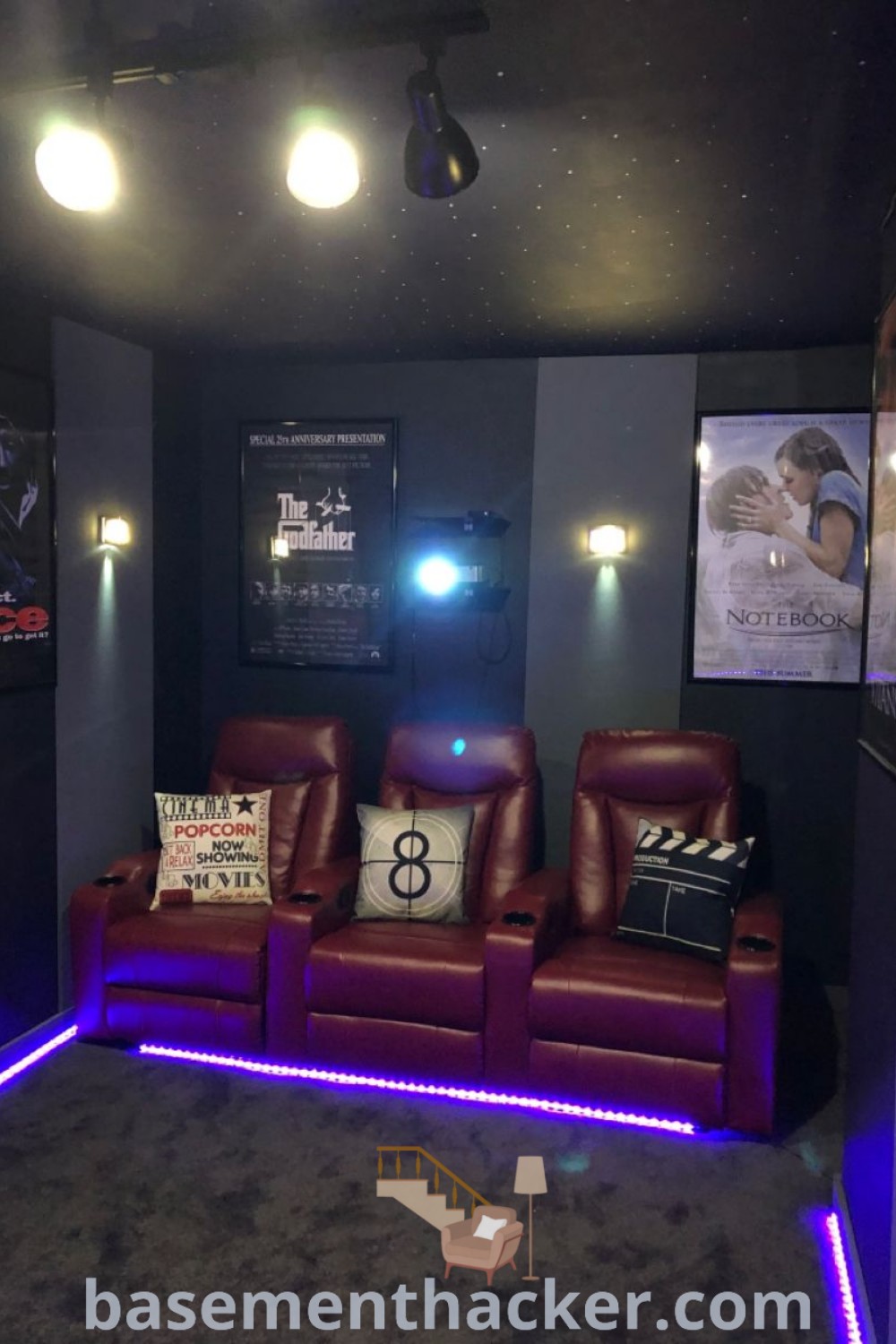 A stylish home theater with two comfortable recliners and decorative pillows, designed as an innovative basement makeover for ultimate entertaining. This cozy cinema room represents the best ideas for a stylish and functional home design, catering to all family members. Discover more design inspiration at basementhacker.com.