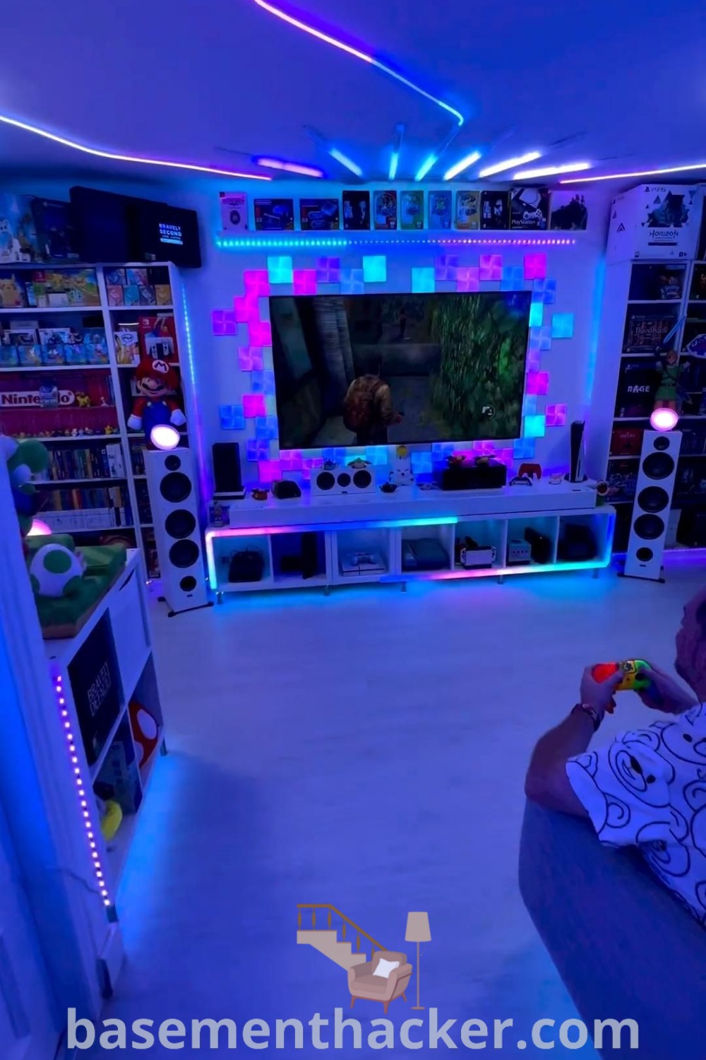 A stylish gaming room featuring a comfortable couch, vibrant LED lights, and organized gaming essentials, perfect for gamers seeking innovative ideas for a cozy and functional setup. Explore more at basementhacker.com.