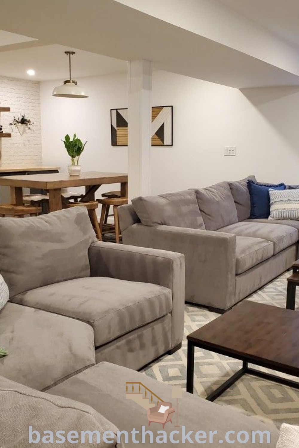 A stylish living room filled with a sectional sofa and various furniture arrangements, showcasing innovative basement makeover ideas for a comfortable and functional space. This basement layout is ideal for entertaining and spending quality time with family. More stylish design ideas are available at basementhacker.com.