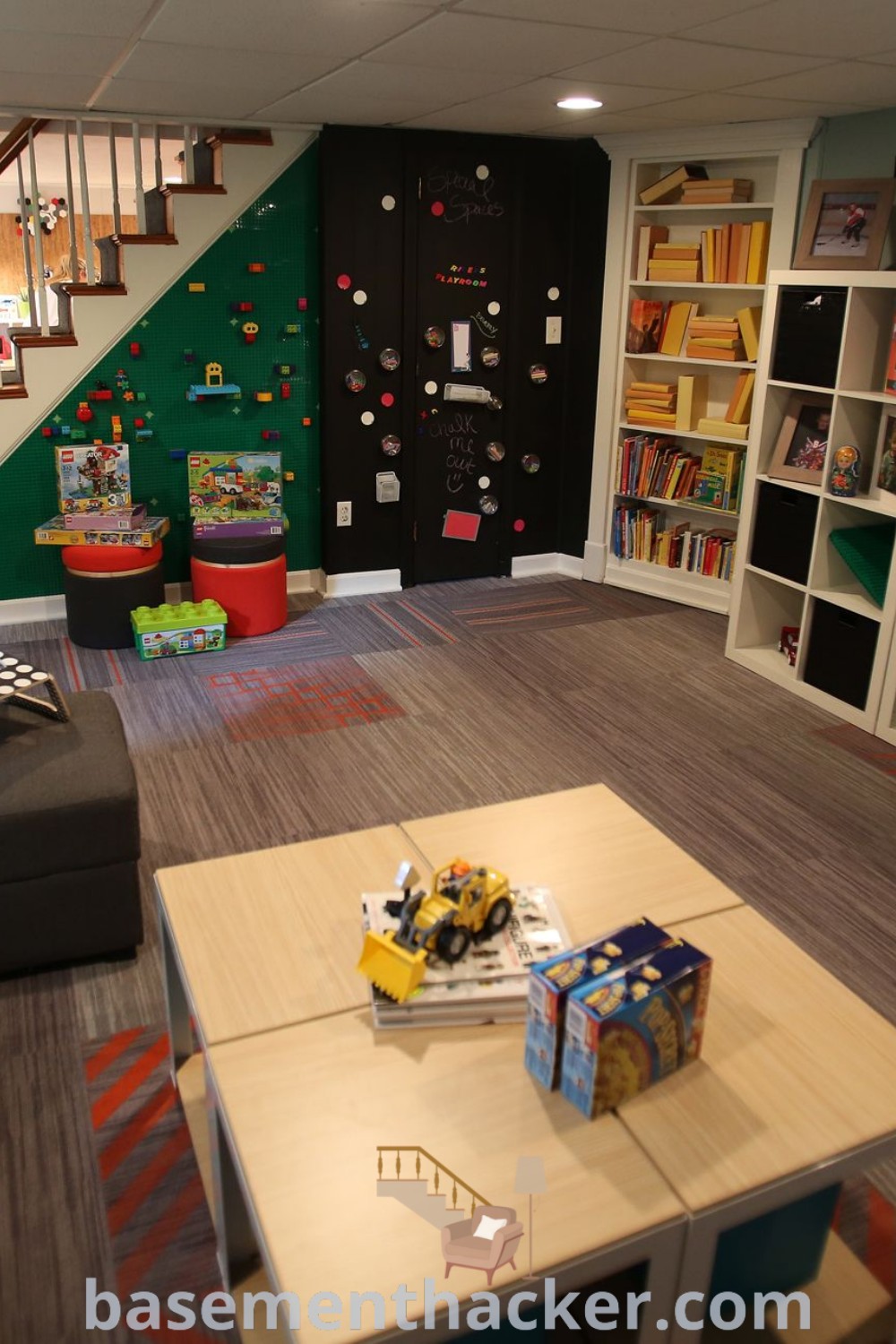 A lively living room converted into a basement playroom filled with furniture and bookshelves, showcasing stylish decor ideas for family rooms, and perfect for a cozy and organized home. Discover more innovative basement makeover ideas at basementhacker.com.
