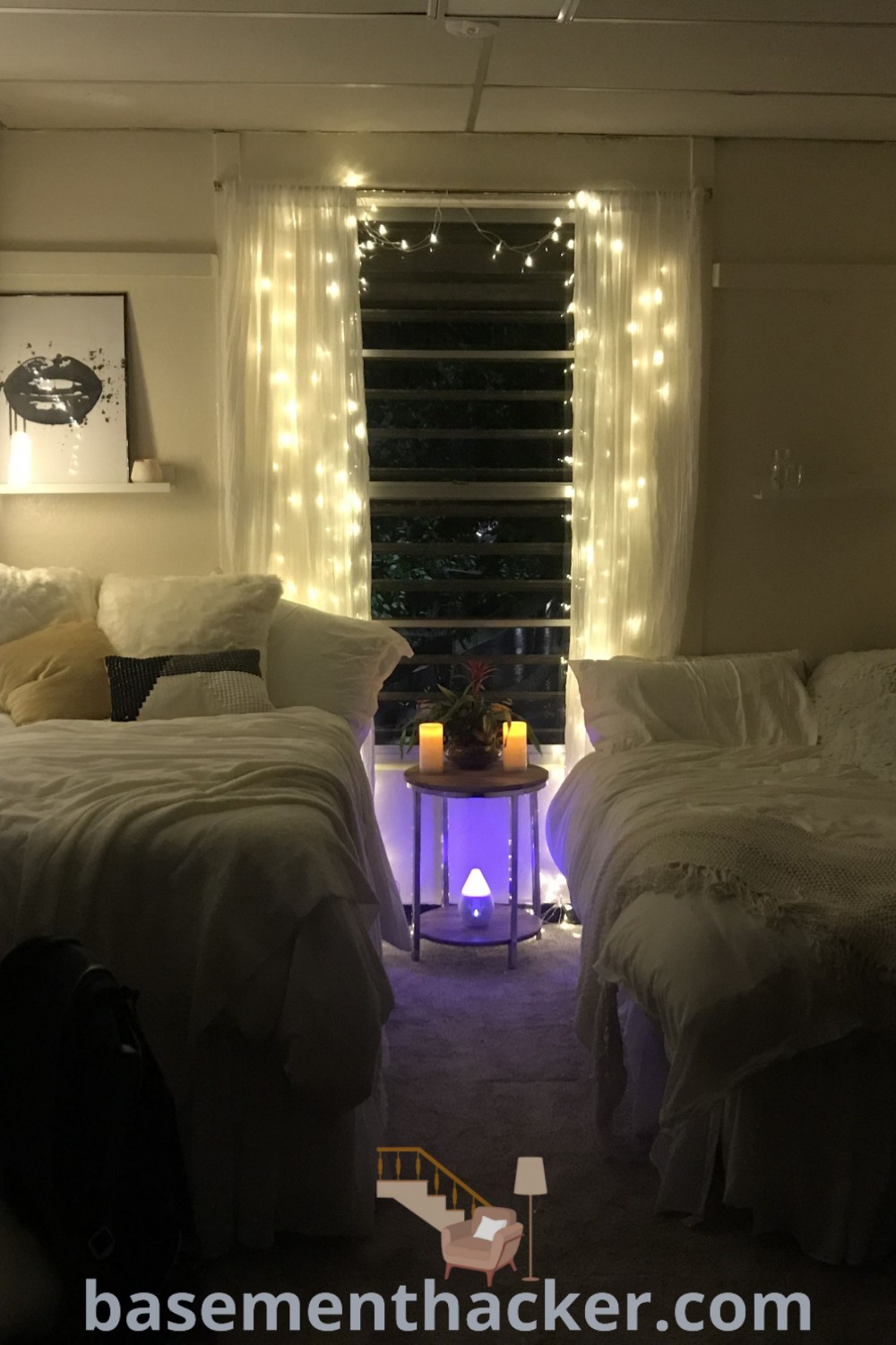 A stylish white bedroom with two beds, wall lights, and windows, showcasing innovative design ideas for small college bedrooms. This fresh decor is perfect for students looking to maximize space and create a cozy atmosphere. Explore more inspirations at basementhacker.com.