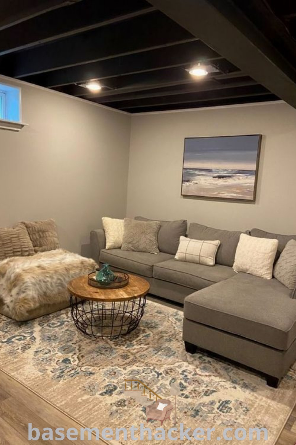 A clean and organized small basement, showcasing design ideas for an ultimate entertaining space with innovative basement makeover ideas. Featuring a cozy rec room, this stylish space is perfect for family activities and relaxation, offering a blend of aesthetic and functional benefits. Discover more on basementhacker.com.