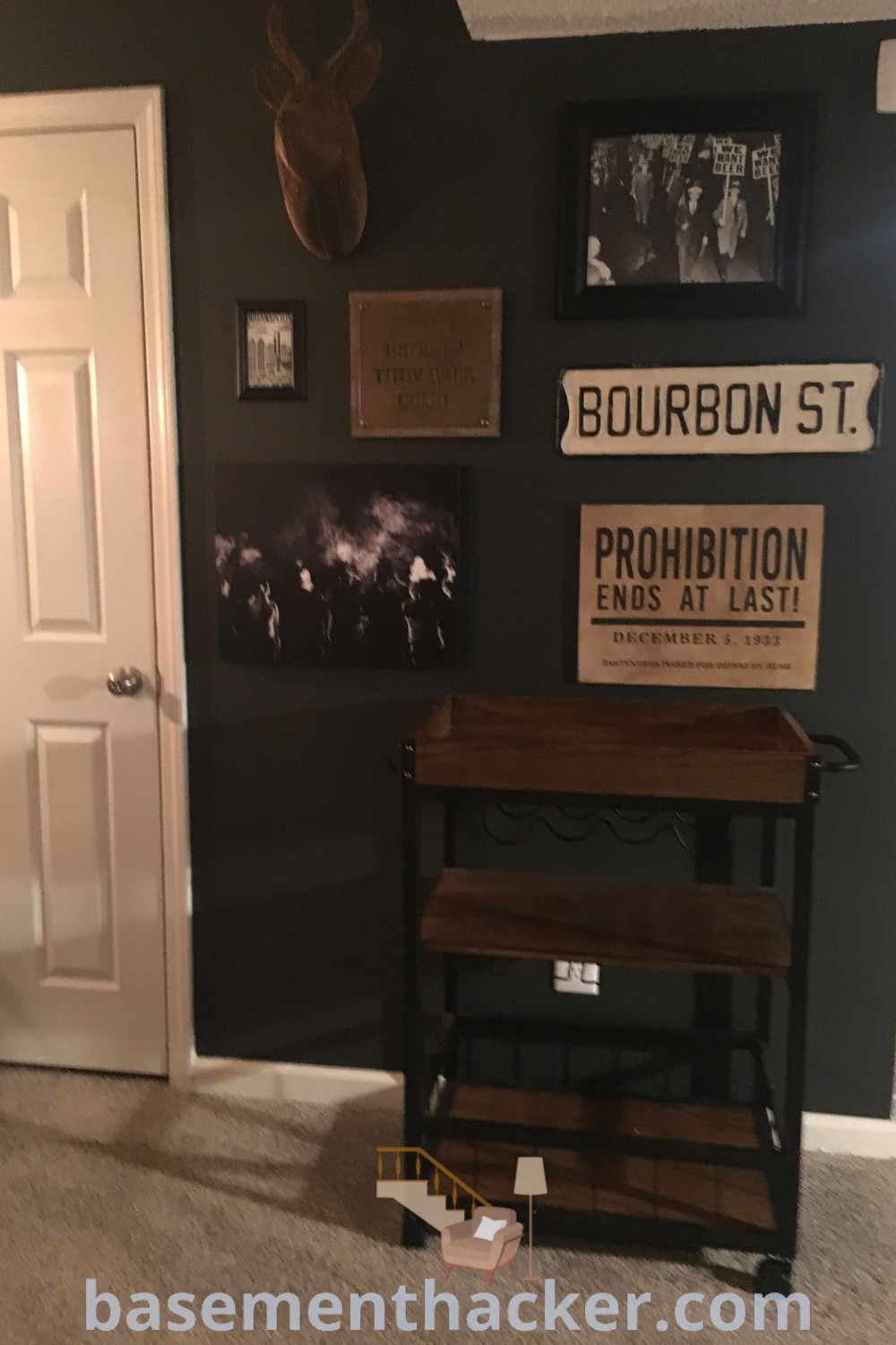 A room with pictures and signs on the wall depicting stylish speakeasy basement ideas, including designs for a home speakeasy and a downstairs bar. This innovative space combines masculine interior design with practical functionality, offering ideas for a cozy and organized home. Discover more about unique basement makeovers at basementhacker.com.