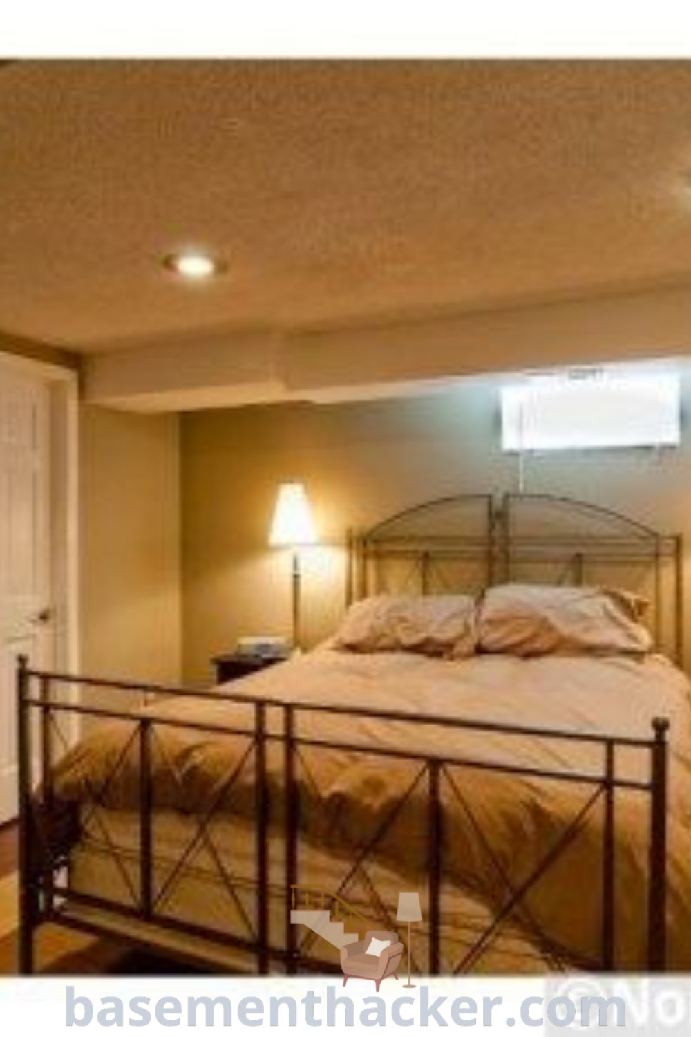 A beautifully designed basement master suite featuring a comfortable bed next to two stylish lamps, showcasing innovative ideas for designing tiny spaces and a functional home. Perfect for basement remodeling inspiration, this space offers practical tips for creating a cozy and organized home. Discover more design ideas at basementhacker.com.