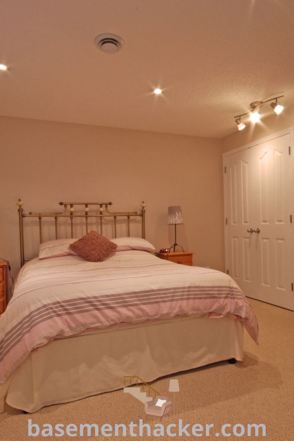 A beautifully designed basement bedroom featuring a neatly made bed and dressers, showcasing a cozy basement bedroom aesthetic. This space is perfect for guests or as a stylish master bedroom, with innovative ideas for uplifting your basement area. Discover more on basementhacker.com.