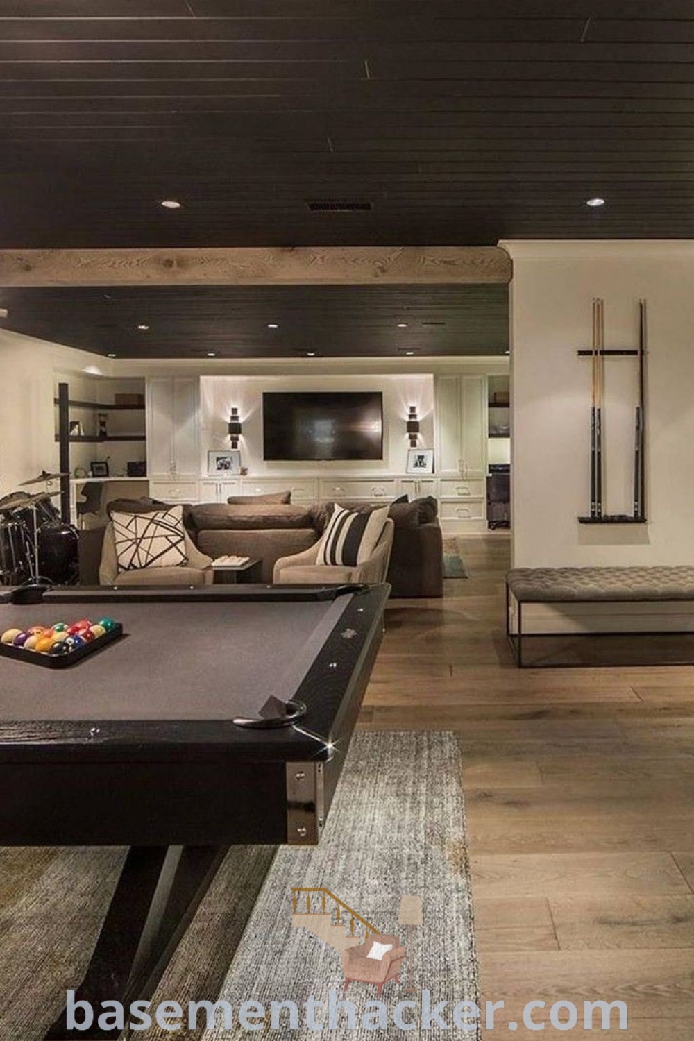 A living room featuring a pool table in a cozy game room basement, designed for ultimate entertaining and stylish family activities. Ideal for basement refinement and decoration, this inviting space highlights innovative ideas for a functional home design. Explore more inspiring decor concepts at basementhacker.com.