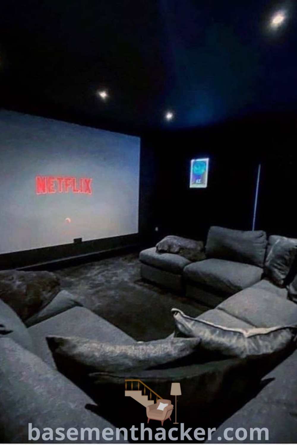 An empty theater room with two cozy couches and a projector screen, showcasing stylish bonus room design ideas perfect for home theaters. Enhance your movie nights with innovative basement makeover ideas for a stunning revamp of your living space. Find more inspirations at basementhacker.com.