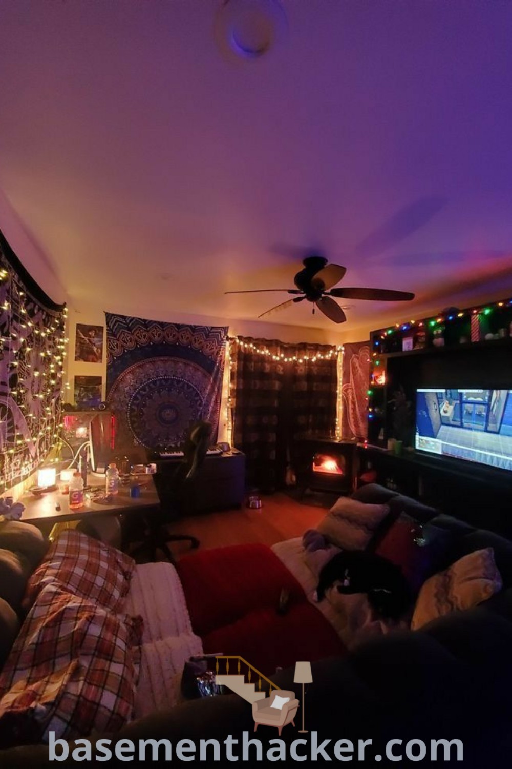 A cozy living room filled with stylish furniture and a flat-screen TV mounted on the wall, showcasing innovative ideas for designing spaces for ultimate entertaining. This inviting hangout room embodies chill vibes and cute room aesthetics, making it perfect for family enjoyment. Discover more design tips at basementhacker.com.