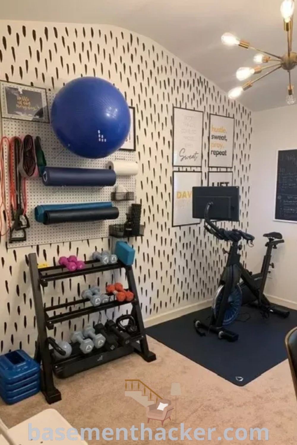 A stylish mini gym at home in a basement, featuring exercise equipment like an exercise bike and vibrant wallpaper, showcasing innovative ideas for designing a cozy and functional workout corner. Explore gym in bedroom concepts and small home gym organization tips at basementhacker.com.