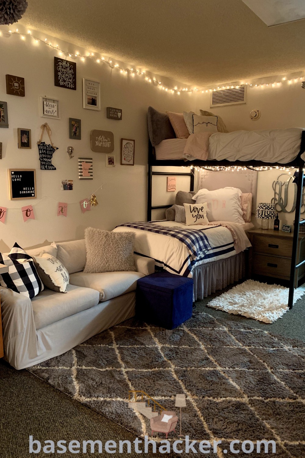 A cozy dorm room with bunk beds, couches, and lights, designed for two to three people. This innovative space showcases dorm room ideas and layout inspirations from basementhacker.com, with decor that enhances functionality and style.