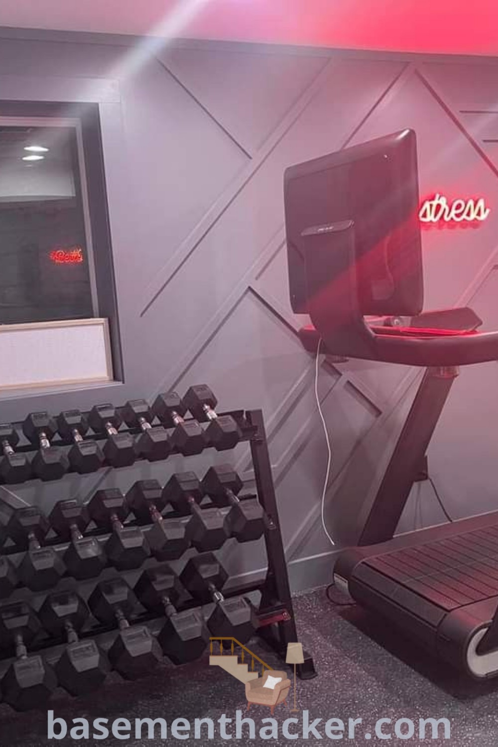 A pink home gym featuring a treadmill and exercise equipment, designed for women with a feminine touch. This stylish at-home gym offers innovative ideas for a cozy and functional space, perfect for those seeking awesome workout room inspiration. Discover more decor ideas at basementhacker.com.