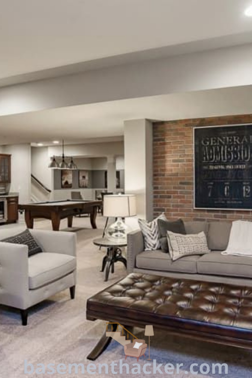 A stylish living room in a basement featuring comfortable furniture and a striking brick wall, showcasing innovative basement remodel ideas and stylish bonus room design ideas for families. This inviting space is perfect for ultimate entertaining and offers practical solutions for a cozy and organized home. For more inspiration, visit basementhacker.com.