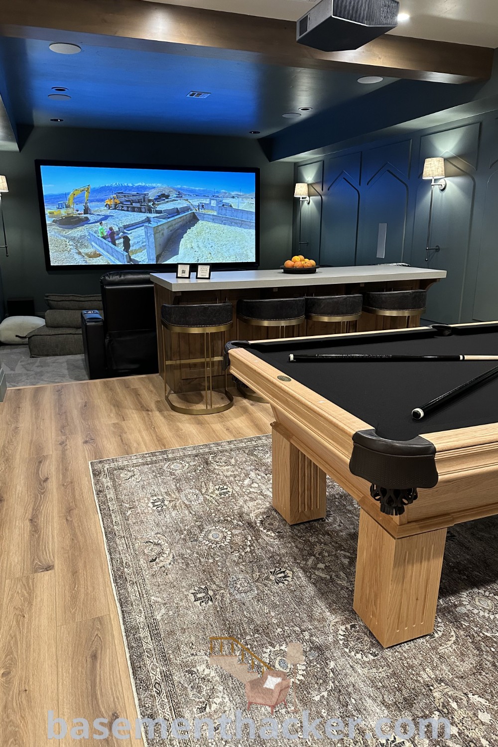 A lively basement game room showcasing a pool table and television, exemplifying innovative ideas for designing stylish bonus spaces. This inviting area highlights the best basement remodeling ideas for family entertainment, enhancing your home decor. Visit basementhacker.com for more on basement makeovers and game room inspirations.