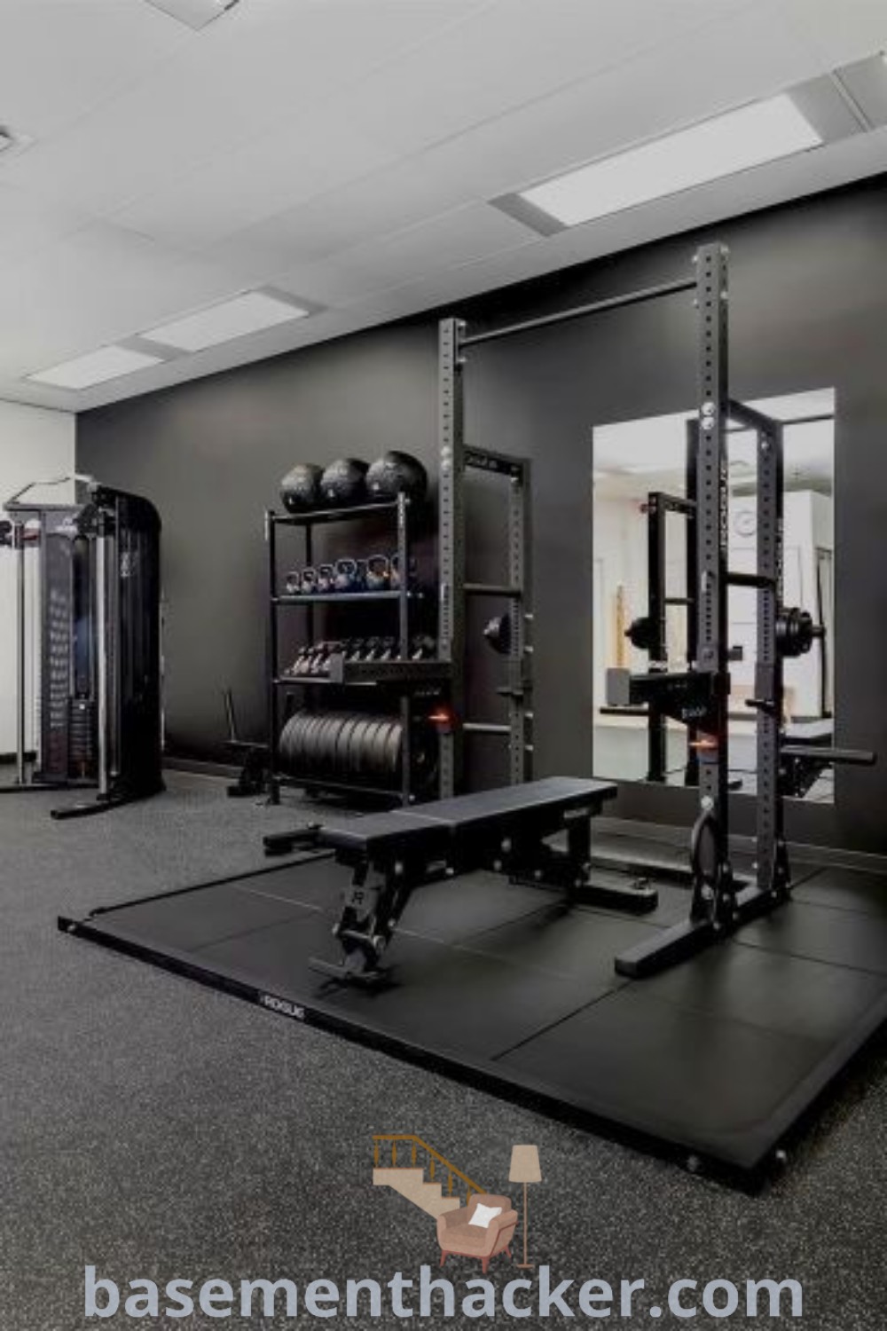 An empty gym with equipment centered and mirrors behind, showcasing innovative ideas for designing a private home gym. Ideal for basement makeovers, it represents awesome garage gym concepts and luxurious home gym ideas. Discover how to create a stylish and functional space at basementhacker.com.