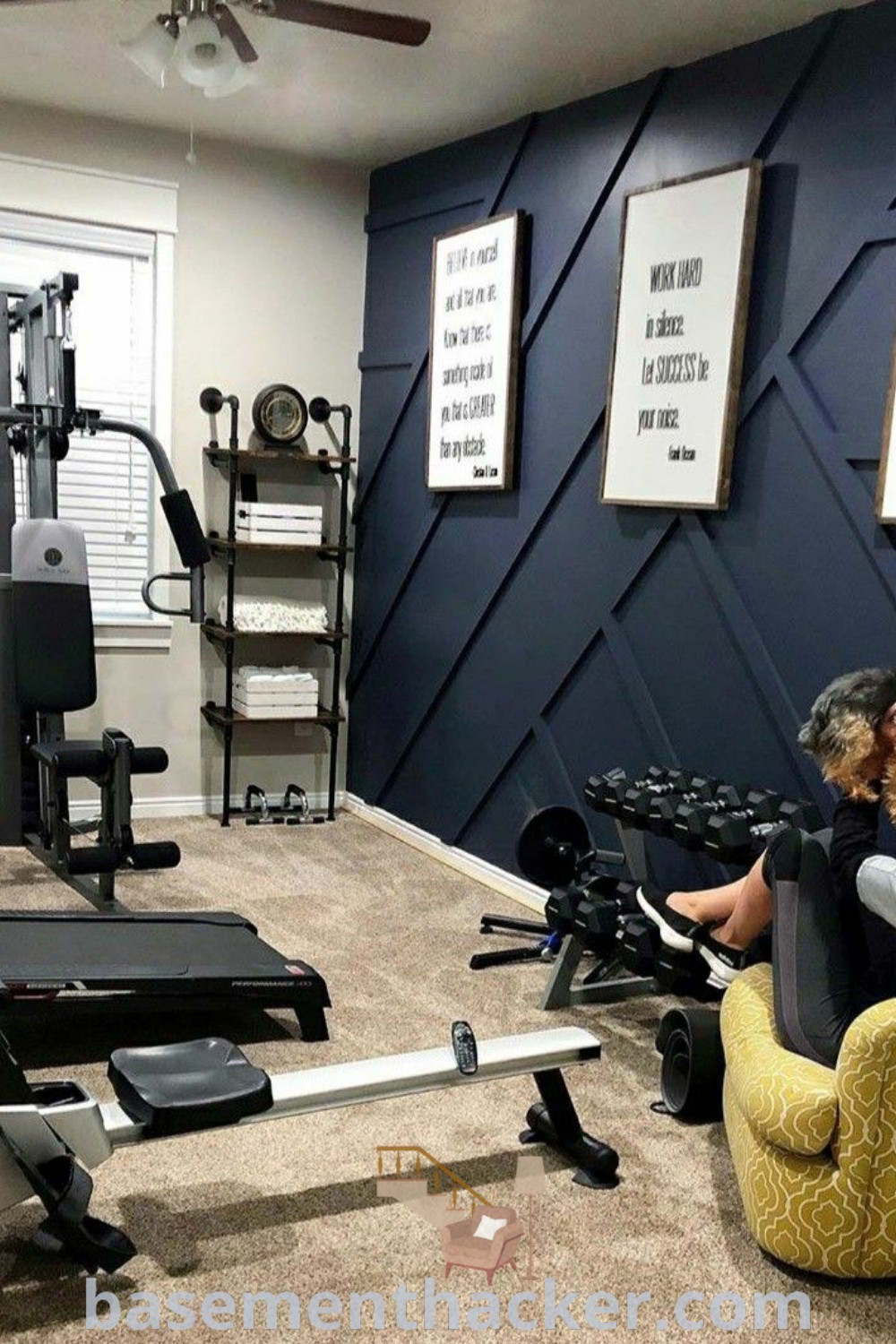 A man and woman enjoying their time in a cozy family basement gym area with equipment set up. This stylish space highlights ideas for a functional home gym, featuring gym signs and decor elements suitable for creative basement makeovers and family-friendly designs. Discover more at basementhacker.com.