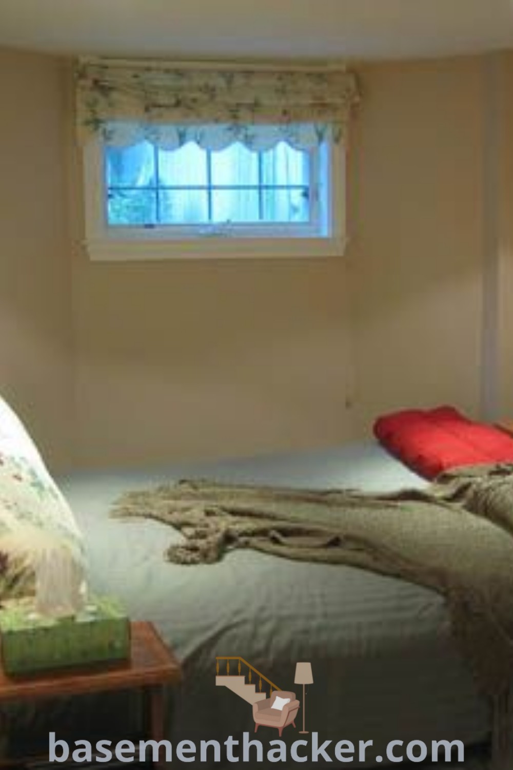 A cozy basement bedroom with a bed next to a bright window and a soft blanket on top. This stylish bonus room design incorporates innovative ideas for maximizing a basement