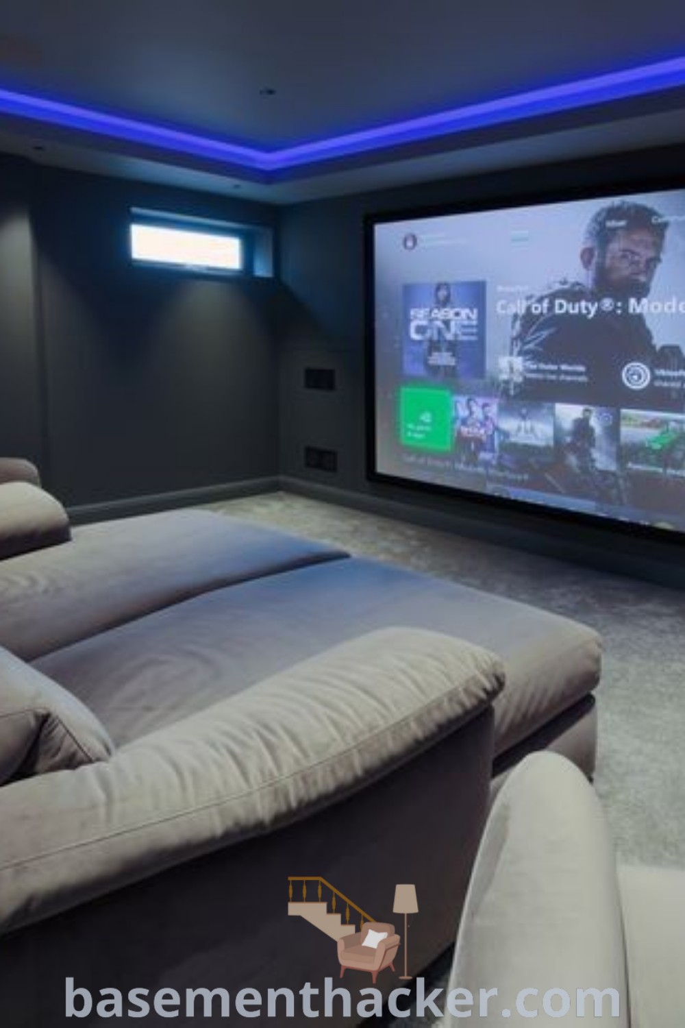 A home theater with two recliners and a projector screen, ideal for ultimate entertaining. This cozy space showcases modern home theater design, perfect for family movie nights. Discover innovative ideas for a stylish and functional home layout at basementhacker.com.