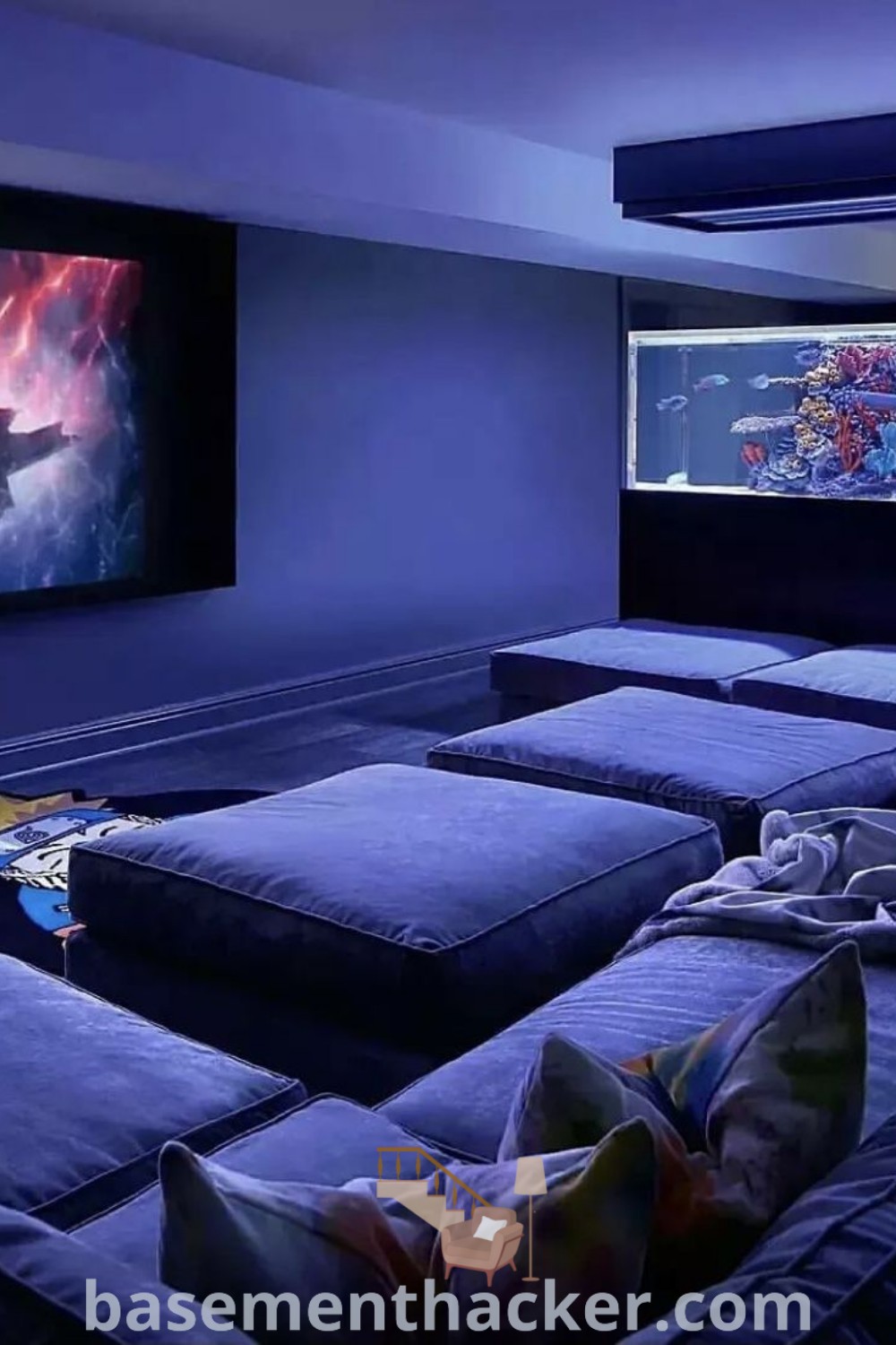 A cozy Couch Pit Movie Room with comfortable couches facing two large screens, ideal for gaming and movie nights. This space showcases innovative ideas for designing a stylish and functional family movie room, making it perfect for basement makeovers. For more inspiration, visit basementhacker.com.