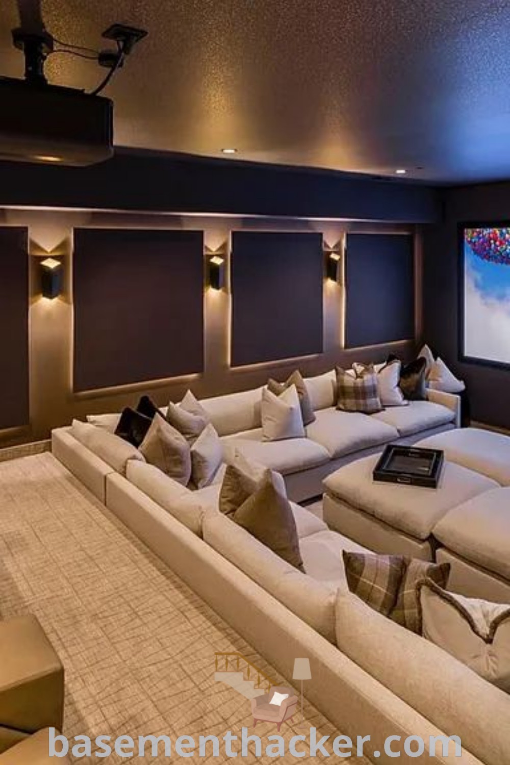 A cozy home theater room with large comfortable couches and a big screen, showcasing innovative design ideas for the perfect movie room with recliners. This stylish space is ideal for entertaining, bringing families together for a great cinematic experience. Visit basementhacker.com for more ultimate entertaining inspirations.
