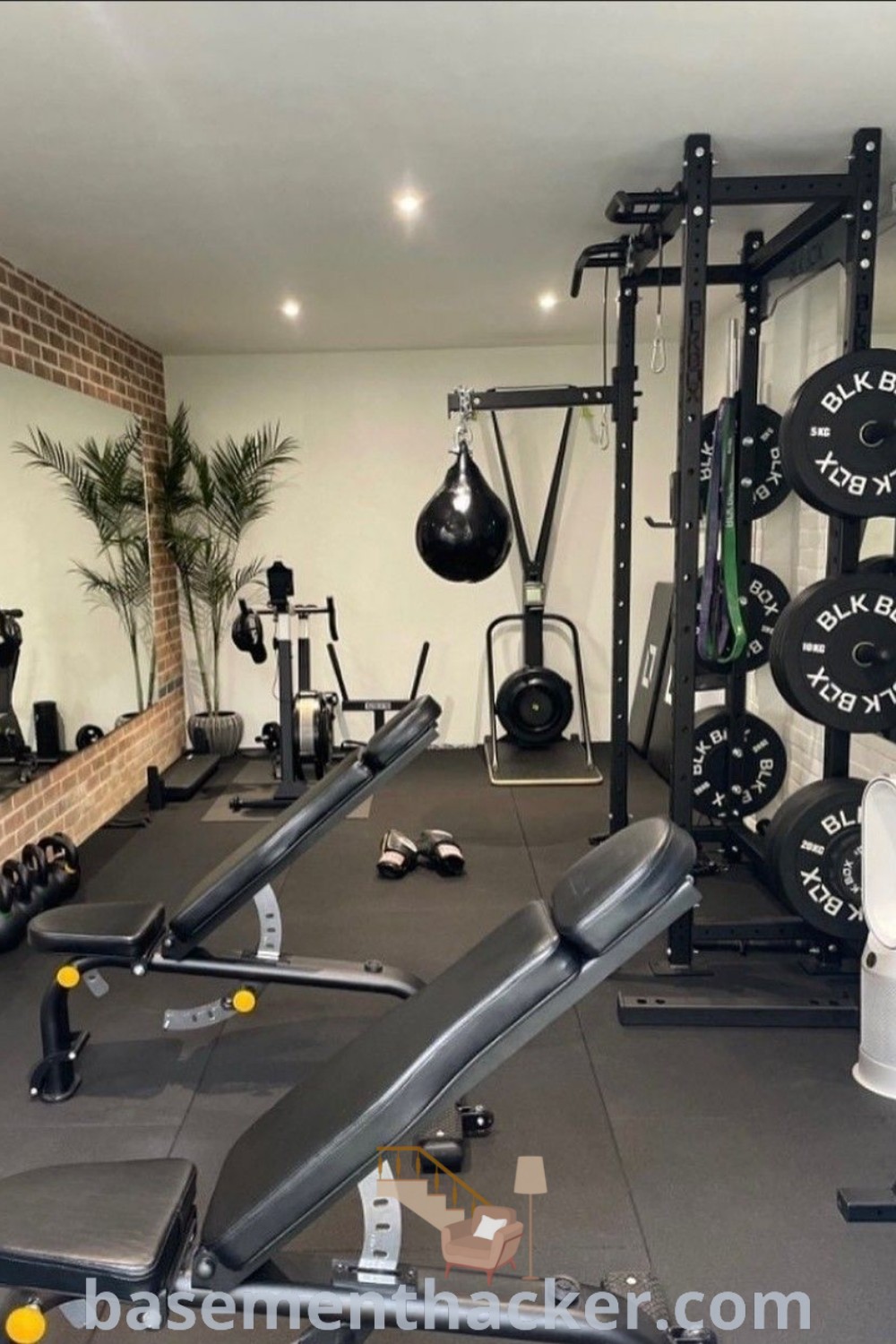 A stylish small gym room equipped with diverse workout equipment, showcasing home gym inspiration and design ideas for a cozy and organized space. Perfect for workout enthusiasts, this gym basement offers innovative ideas for a stunning revamp. Explore basementhacker.com for more creative concepts.