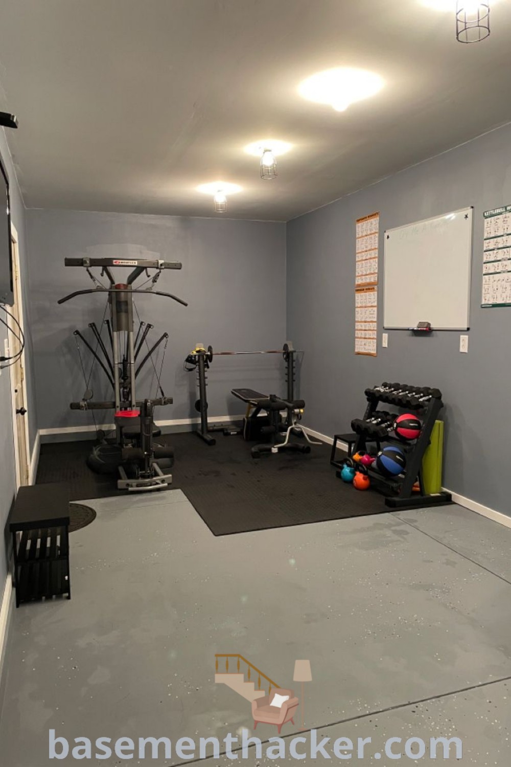 A small home gym featuring exercise equipment in the corner, designed for stylish and functional use. This home gym room exemplifies the best home gym design ideas, perfect for creativity and family enjoyment. Discover innovative ideas for your space and find more inspiration at basementhacker.com.