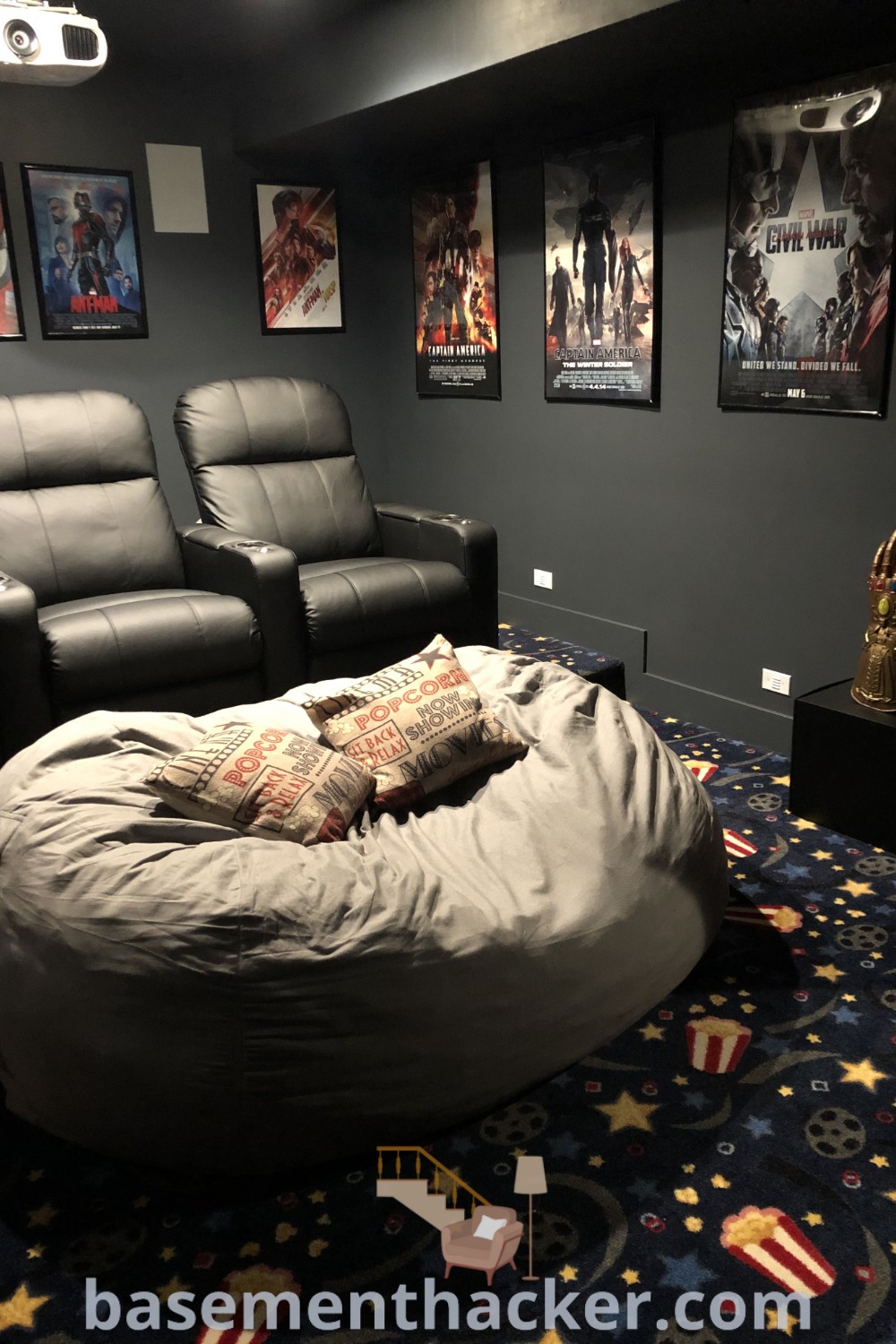 A cozy living room with a large bean bag chair positioned centrally, surrounded by three movie posters on the wall, showcasing innovative ideas for designing a stylish movie room that enhances the aesthetic for ultimate entertaining. Find more inspiration for cozy home theater setups at basementhacker.com.