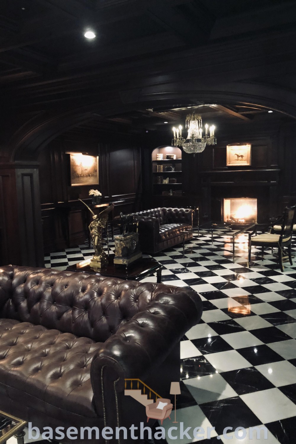 A living room featuring black and white checkered flooring, elegant chandeliers, and leather couches, capturing the essence of Gatsby Bar and Gentleman