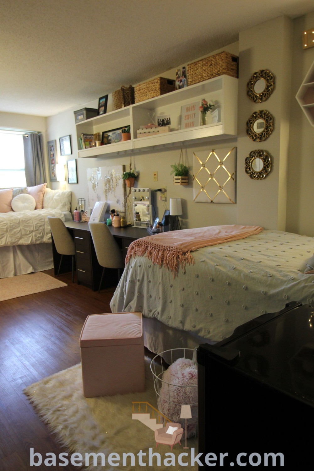 A bright university dorm room with two beds, a desk, and shelves, showcasing innovative design ideas for a cozy and organized home perfect for college life. This space, inspired by Granville Towers, provides stylish dorm room ideas that enhance comfort and functionality, making it ideal for university students. Discover more at basementhacker.com.