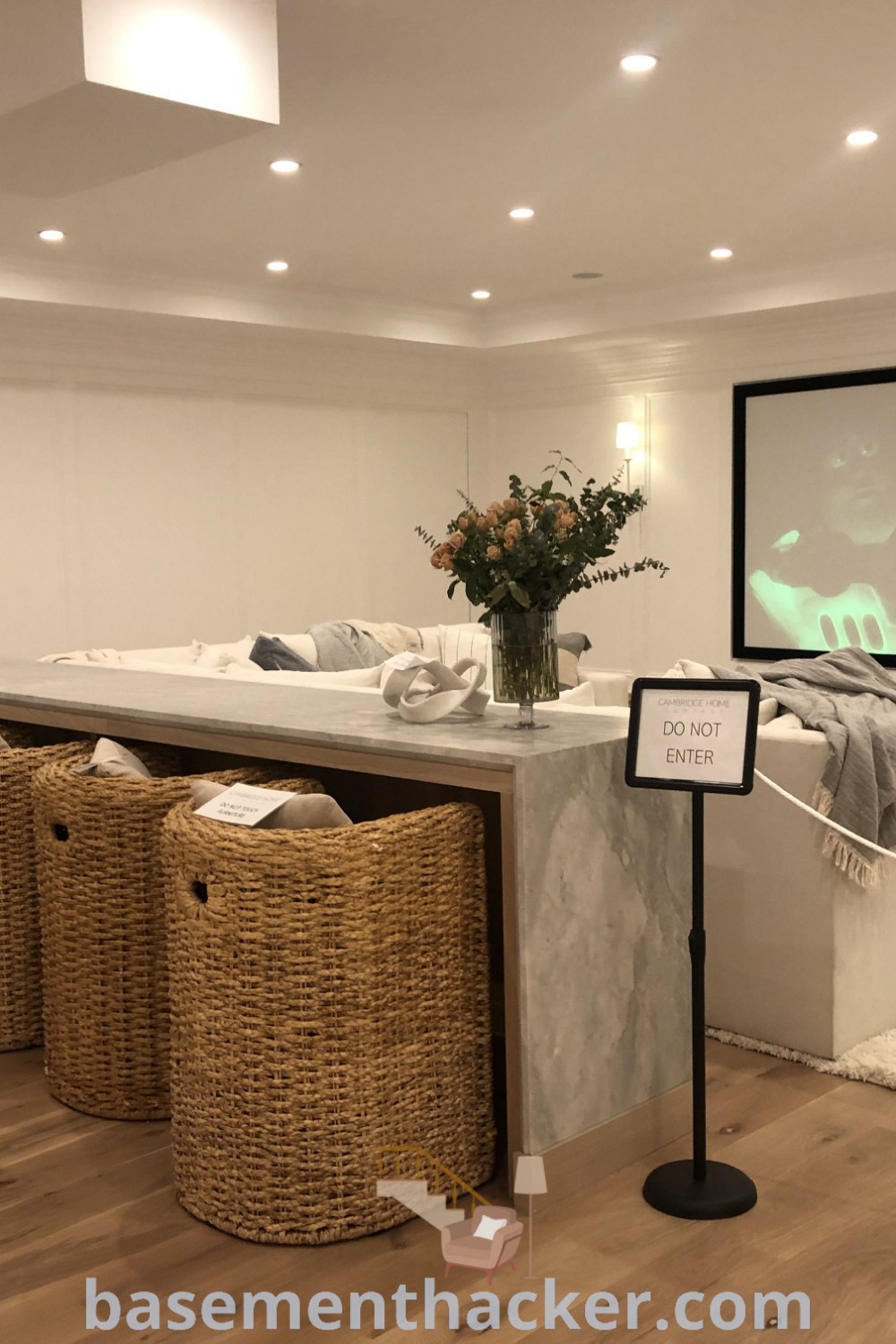 A cozy basement movie room with stylish baskets, a projector screen, and a basement snack bar, showcasing innovative ideas for designing the ultimate entertaining space. Explore more on basementhacker.com for the best basement makeover ideas that create a stylish and functional bonus room for families.