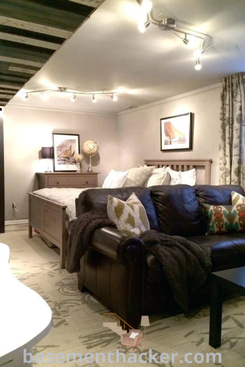 A cozy living room filled with furniture and decor, showcasing stylish bonus room design ideas for a basement turned into apartment, featuring minimalist basement bedroom ideas. This space serves as a perfect example of innovative basement makeovers and offers inspiration for a cozy and organized home. More design ideas available at basementhacker.com.