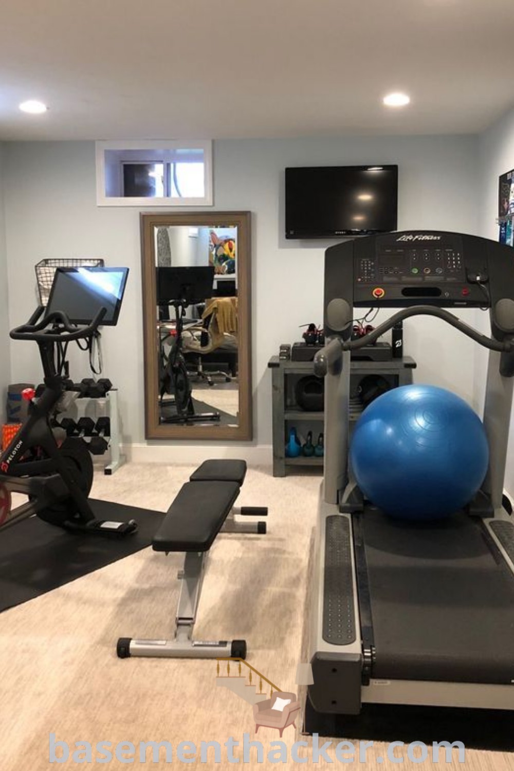 A small home gym featuring an exercise bike, treadmill, and exercise ball in a stylish basement setup, showcasing innovative ideas for your ultimate workout area. Perfect for maximizing space with functional decor, this home gym design can inspire effective basement makeovers. Discover more ideas at basementhacker.com.