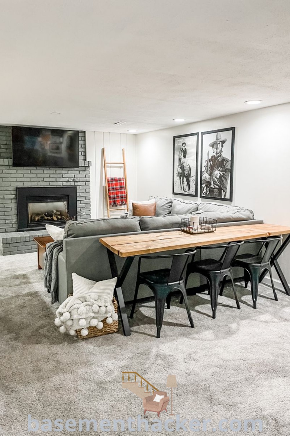 A cozy living room scene showcasing furniture arrangements with a fireplace and wall-mounted TV, highlighting innovative ideas for designing small spaces. This image captures stylish bonus room design ideas for families seeking functionality and comfort, featured on basementhacker.com.