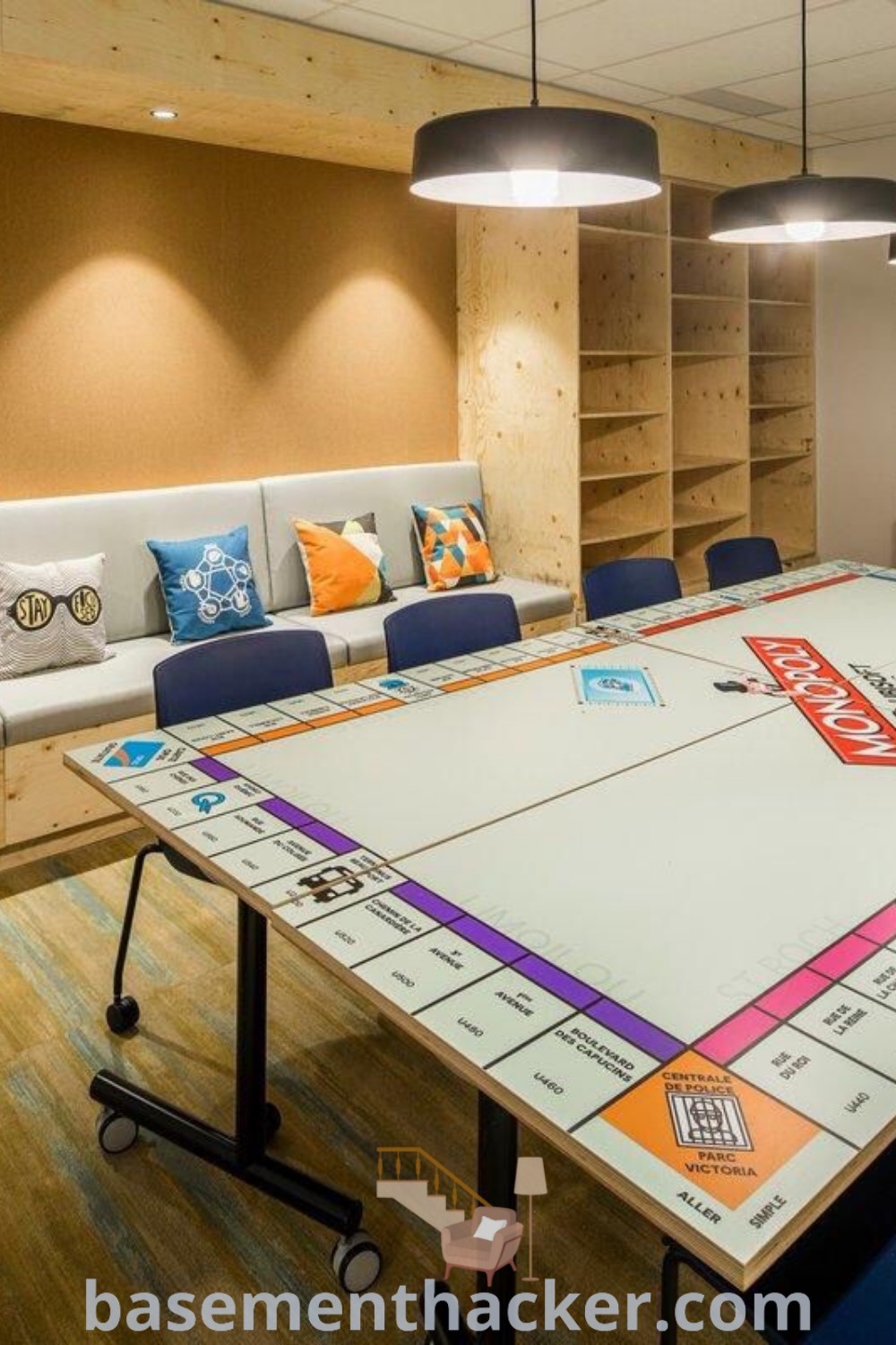 A stylish board game table in an office setting, featuring decor that exemplifies innovative ideas for designing a fun game room. This space showcases activity room ideas for adults, providing an entertaining area ideal for family engagement. For more inspiration on stylish bonus room design ideas and effective basement makeovers, visit basementhacker.com.