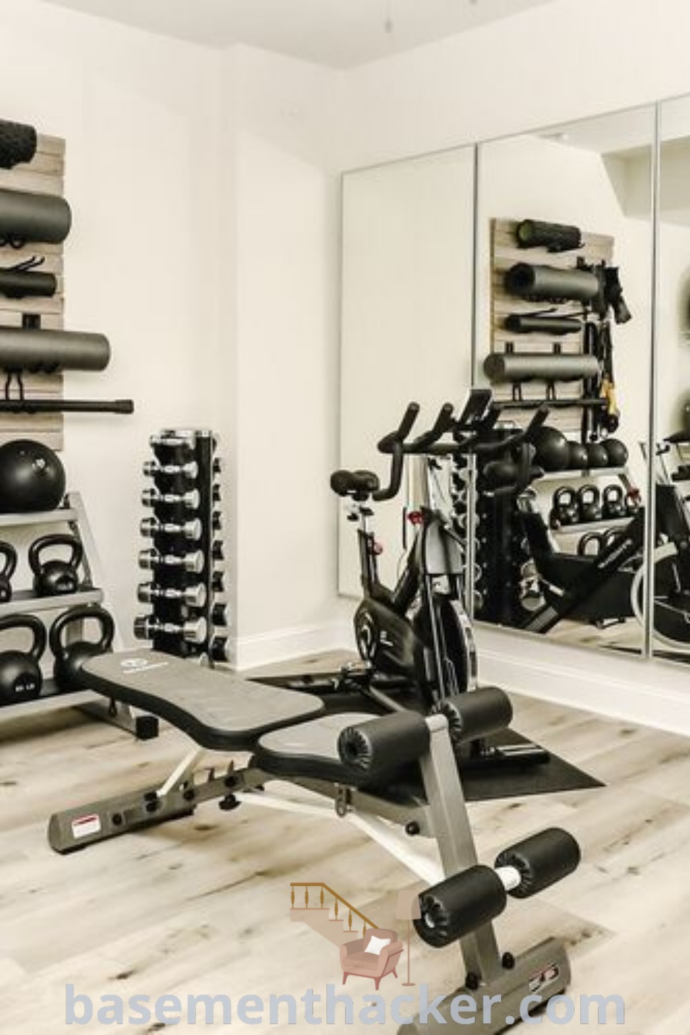 A cozy home gym in a basement with exercise equipment at the center, complemented by shelves filled with personal items. This gym space serves as an inspiring workout area, showcasing innovative ideas for stylish and functional home designs. Explore more design inspirations at basementhacker.com.