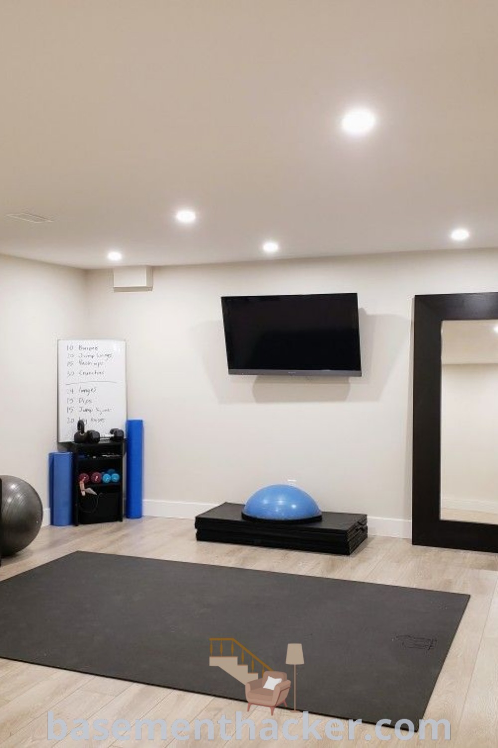A stylish home gym in the basement with exercise mats, televisions, and various workout equipment, including a Plyo box and Bosu ball. This innovative basement design from basementhacker.com showcases practical ideas for creating a functional and inviting workout space that the whole family will enjoy.