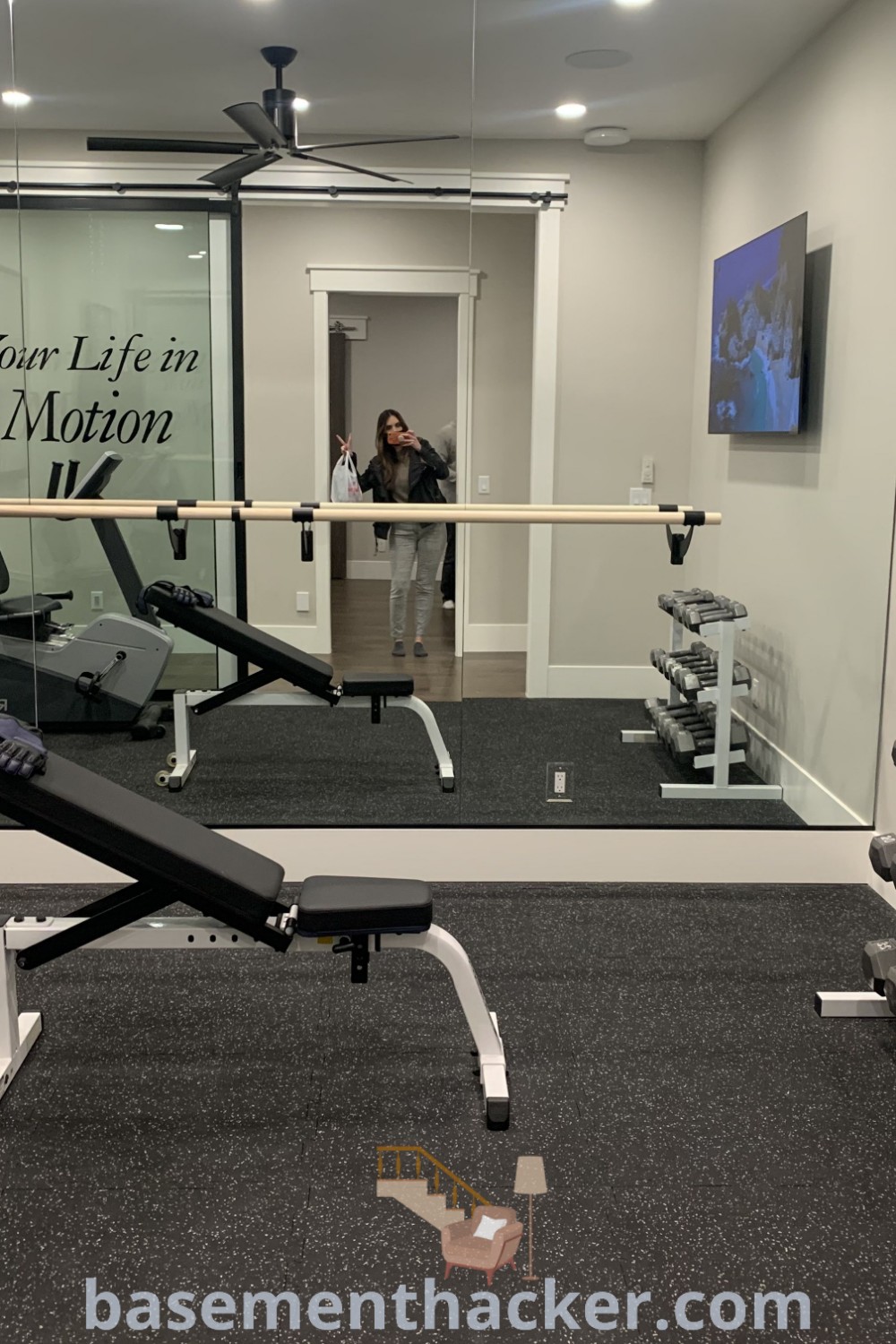 A clean and functional home gym in the basement, showcasing innovative ideas for a stylish and organized workout space. This design offers insights for creating an engaging environment for exercise enthusiasts, with features from basementhacker.com to inspire your ultimate home gym makeover.