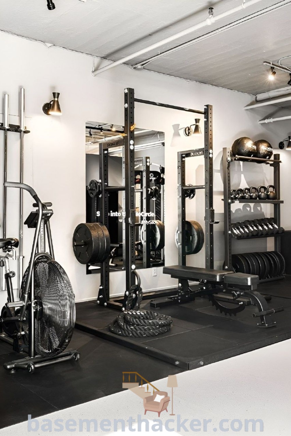 A clean and ready-to-use home gym interior design featuring innovative ideas for a stylish and functional home setup. This private gym, located in downtown Montreal, exemplifies the best in gym design interior, providing inspiration for garage gyms and building your own dream home gym. Find more design ideas at basementhacker.com.