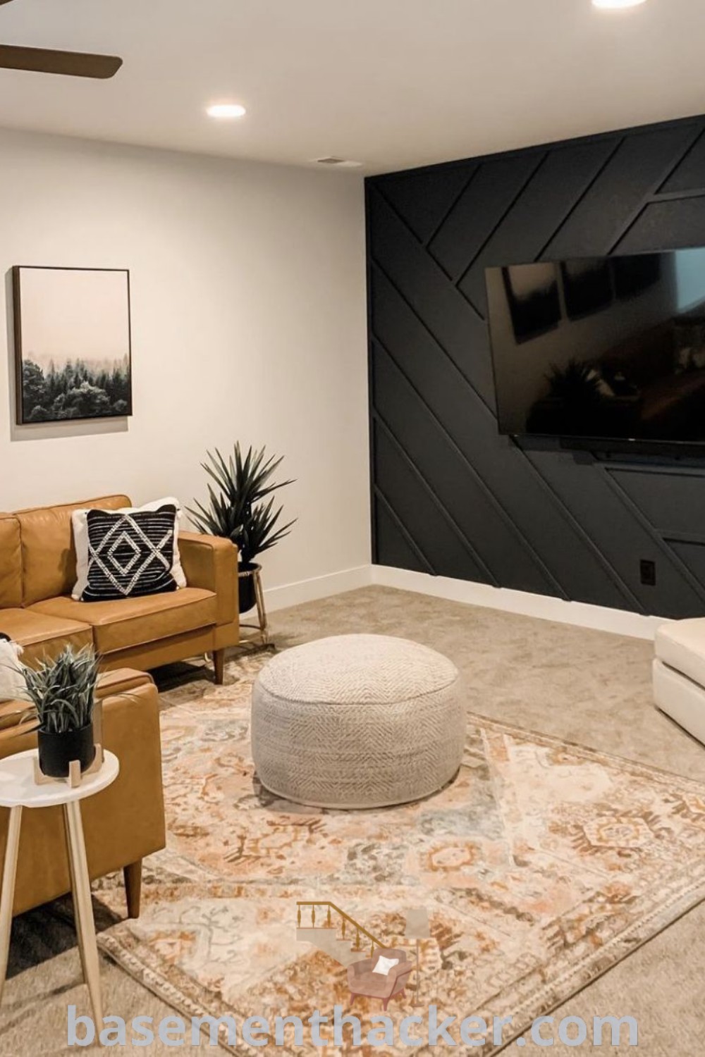 A living room filled with earth tone furniture, featuring a flat screen TV mounted on a stylish basement rec room tv wall. This cozy layout offers innovative ideas for designing a functional and stylish bonus space, perfect for family gatherings or entertainment. Explore more on basementhacker.com.