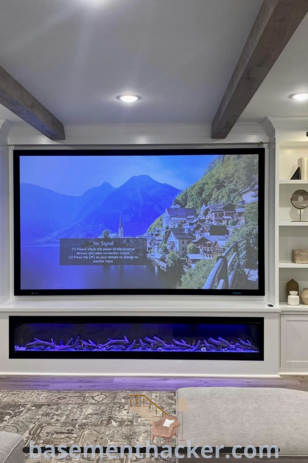 A large screen TV mounted in a beautifully designed basement with a cozy sectional seating area and a pool table, showcasing innovative ideas for basement projector walls and stylish bonus space for ultimate entertaining at basementhacker.com.