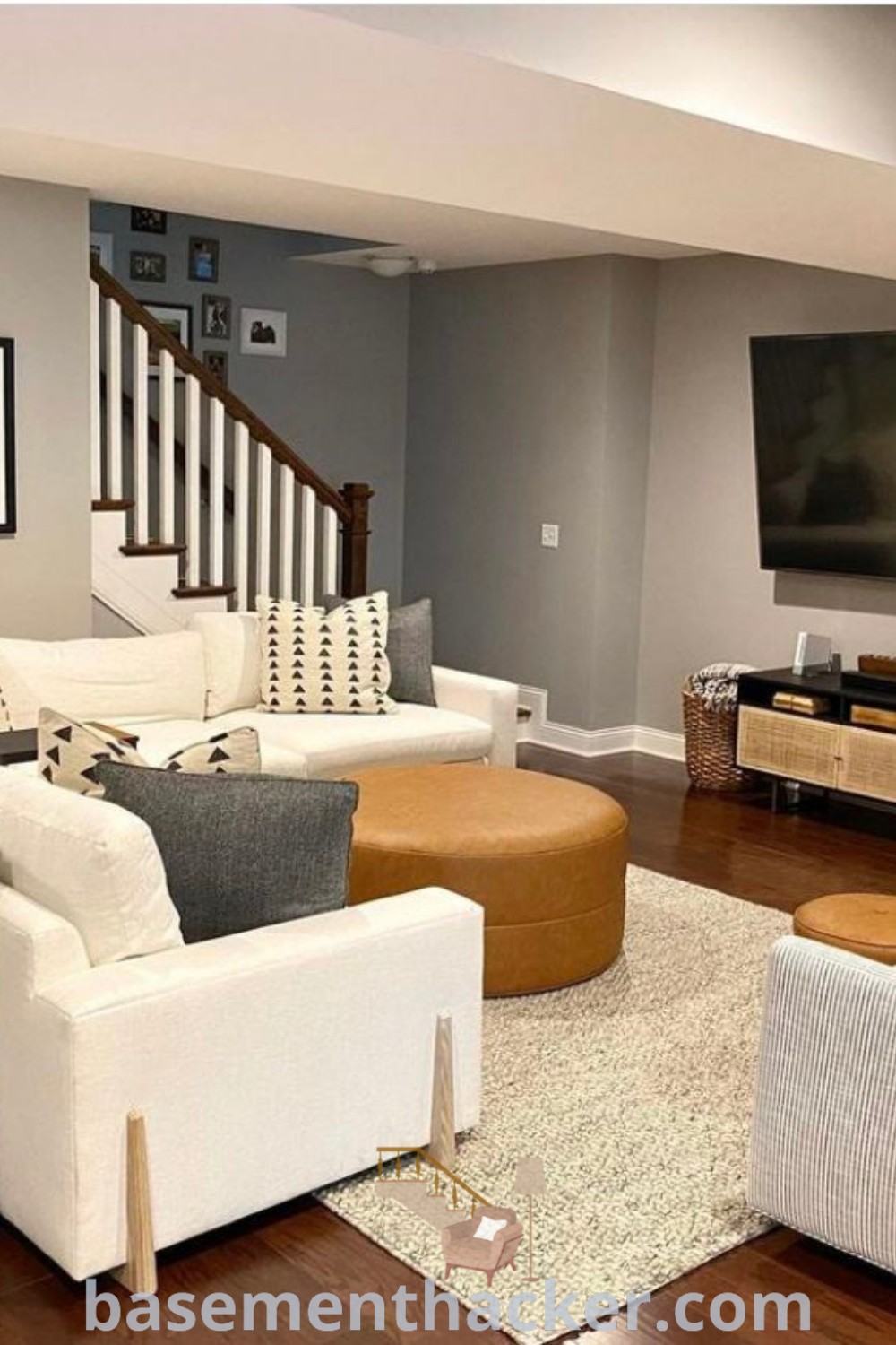 A cozy basement living room featuring plush furniture and a flat screen TV above a fireplace, showcasing innovative basement makeover ideas for a stunning revamp. This space is perfect for ultimate entertaining and includes stylish home decor suggestions available at basementhacker.com.