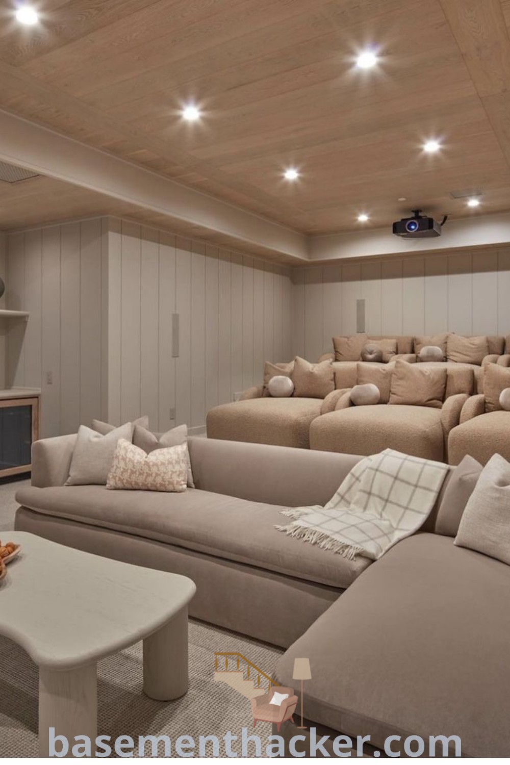 A cozy farmhouse movie room filled with lots of furniture, designed for ultimate entertaining as a home theater room. This space incorporates innovative ideas for designing stylish bonus room decor, ideal for creating a welcoming environment for movie nights. Discover more about home cinema room inspirations at basementhacker.com.