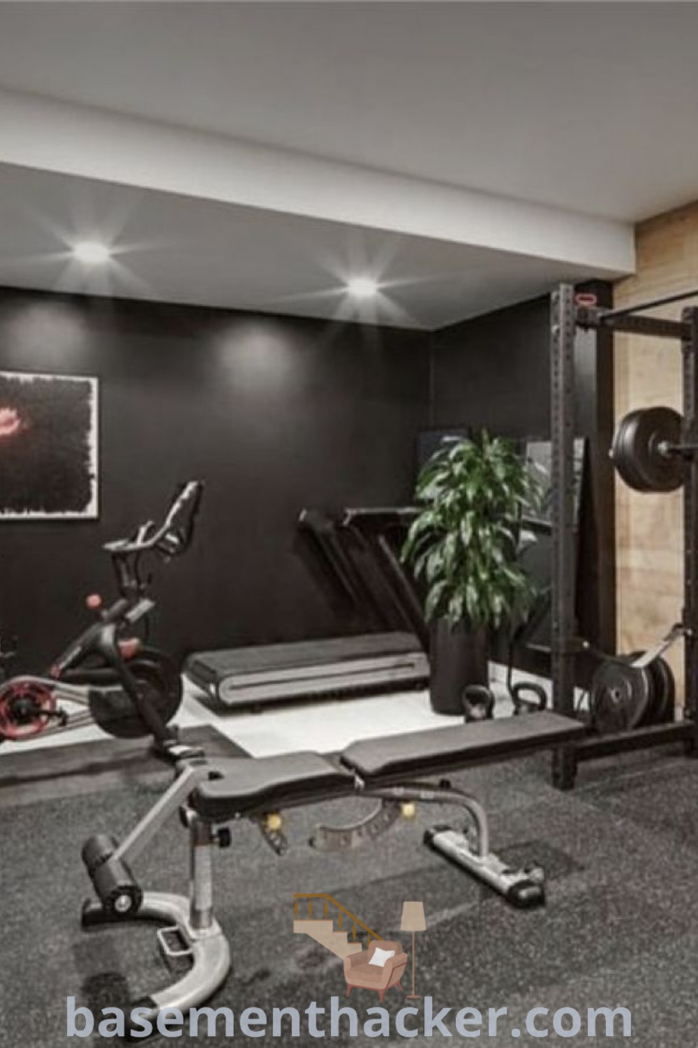 A modern home gym featuring exercise equipment in the corner with a black wall, showcasing innovative ideas for designing a stylish and functional workout space. This home exercise room offers design ideas that enhance both aesthetics and functionality, making it perfect for families. Explore more home gym inspirations at basementhacker.com.