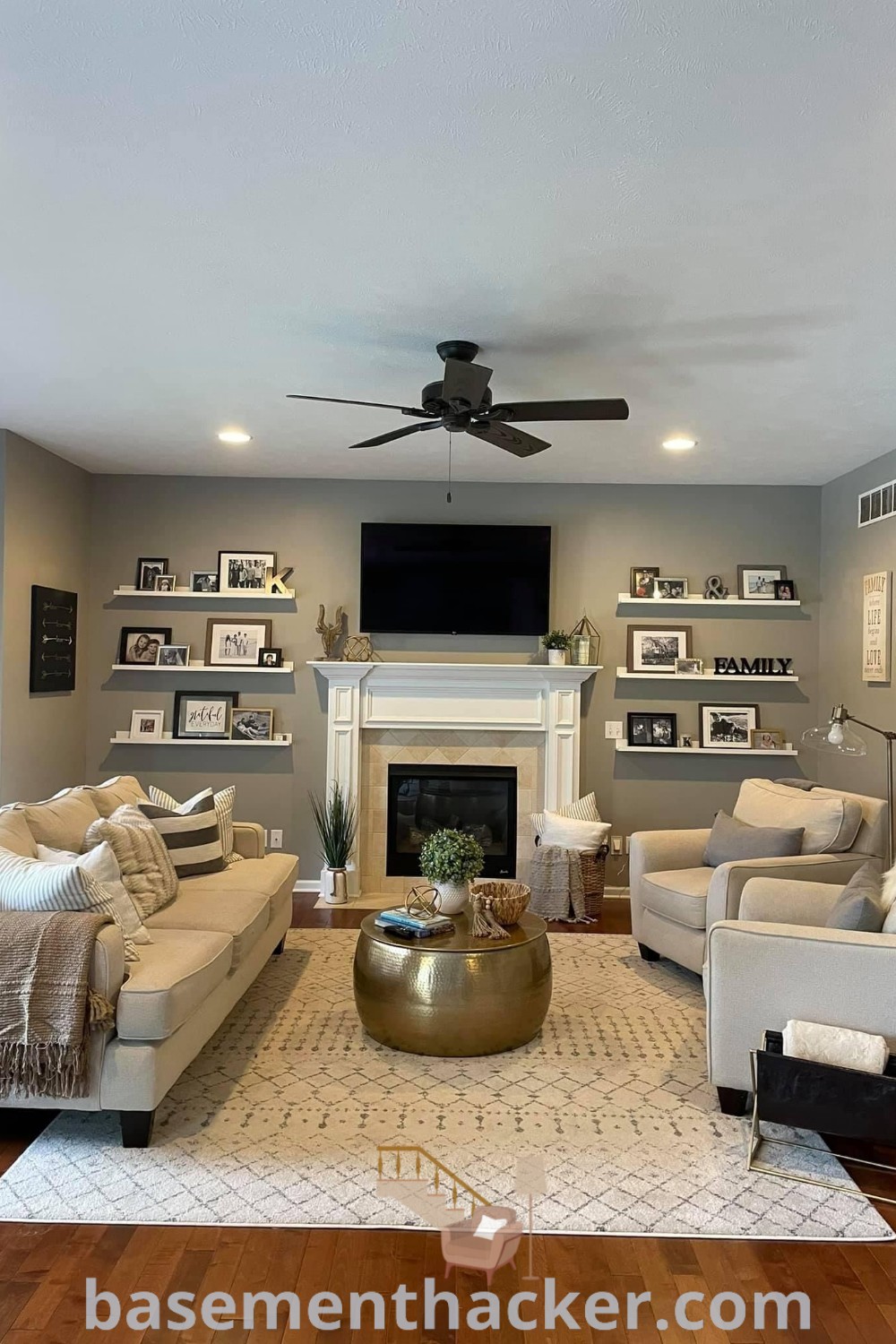 A cozy living room with a fireplace, stylish furniture arrangement, and a flat screen TV mounted above the fireplace, showcasing small living room ideas for a ranch house. This design offers innovative furniture layout for a functional and inviting space for family gatherings. Visit basementhacker.com for more innovative ideas for designing your living area.