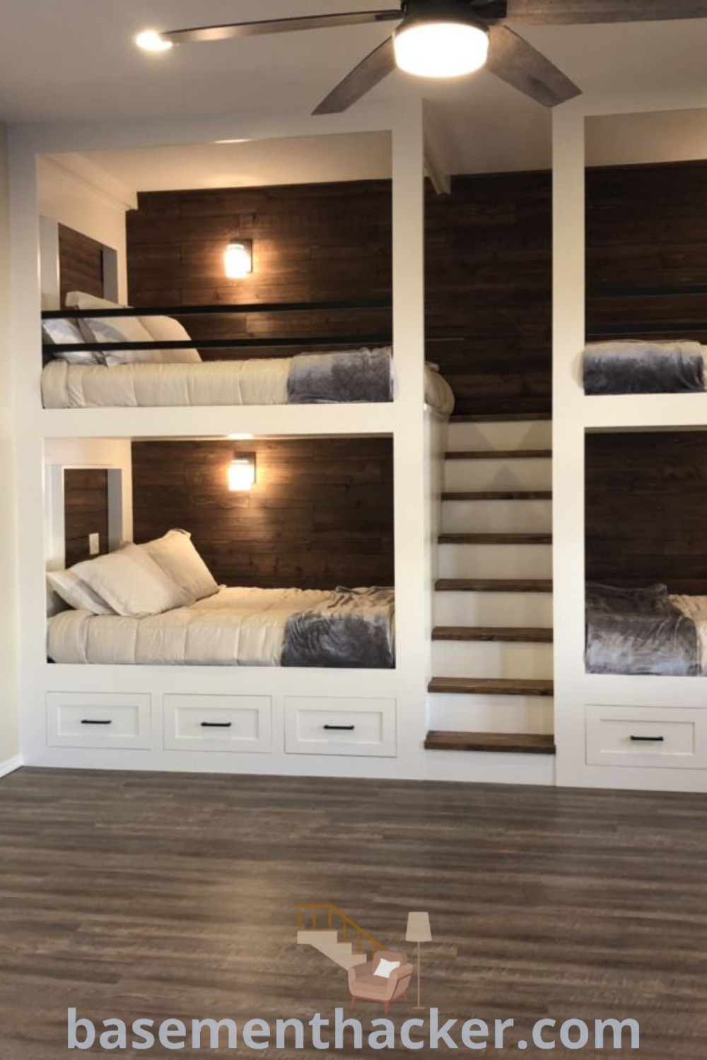 A room with three bunk beds, two TVs, and stylish decor for optimal comfort, showcasing split room bunk bed designs, small bunk room ideas, and innovative basement makeover concepts for ultimate entertaining. Perfect for sleepovers, this space offers the best basement remodeling ideas at basementhacker.com.