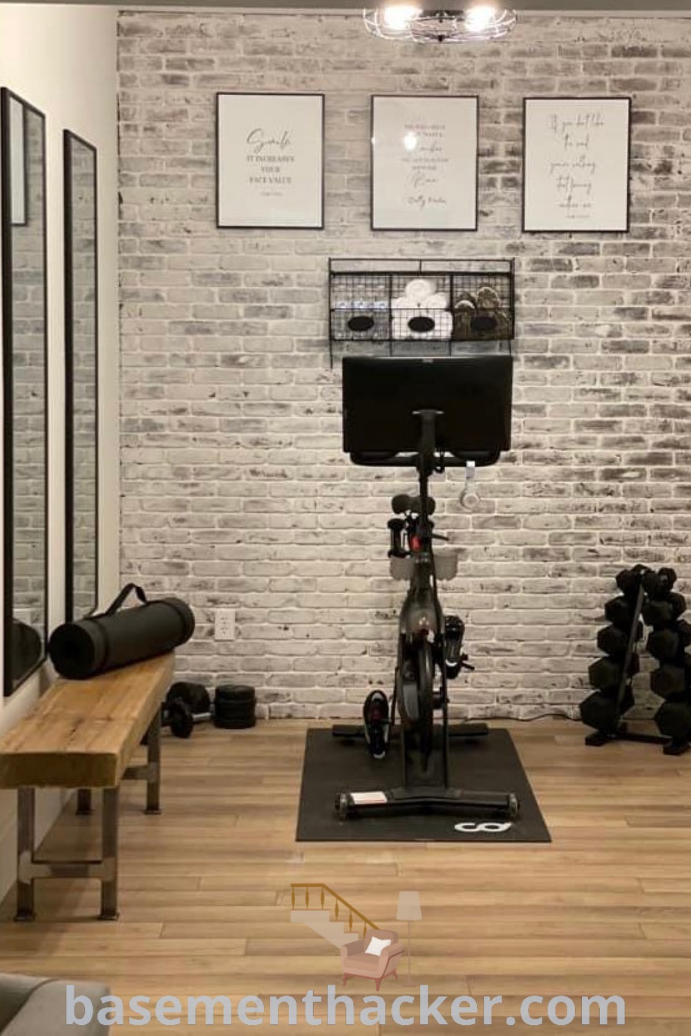 A stylish detached workout room with a bike, exercise equipment, and mirrors reflecting the space, showcasing innovative ideas for designing a home gym. This gym blends function and aesthetics, ideal for basement makeover inspirations from basementhacker.com.