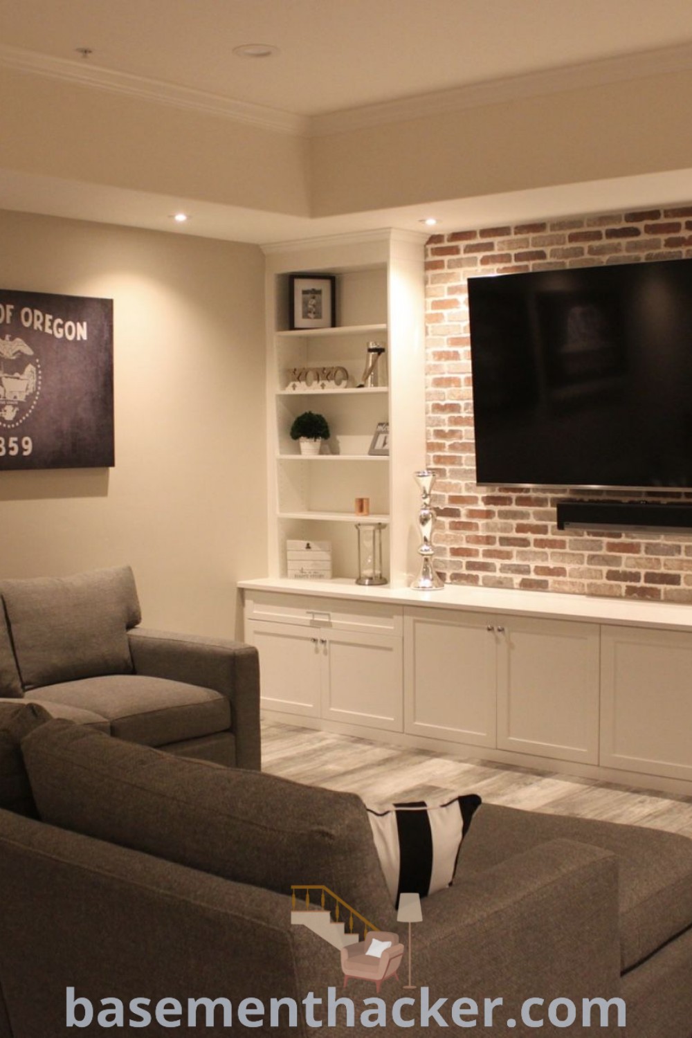 A cozy basement family room with furniture, a flat-screen TV mounted over a fireplace, showcasing basement living room decor ideas and innovative ideas for designing a stylish and functional home. Discover more creative spaces at basementhacker.com.