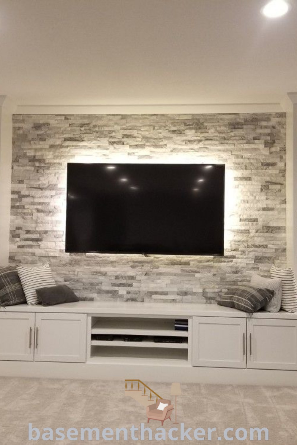 A well-designed living room with a built-in entertainment center, a comfortable couch, and a TV on the wall, showcasing innovative ideas for basement living. This space highlights stylish basement design ideas and the best basement remodeling options for creating a cozy and organized home. Visit basementhacker.com for more inspiration.