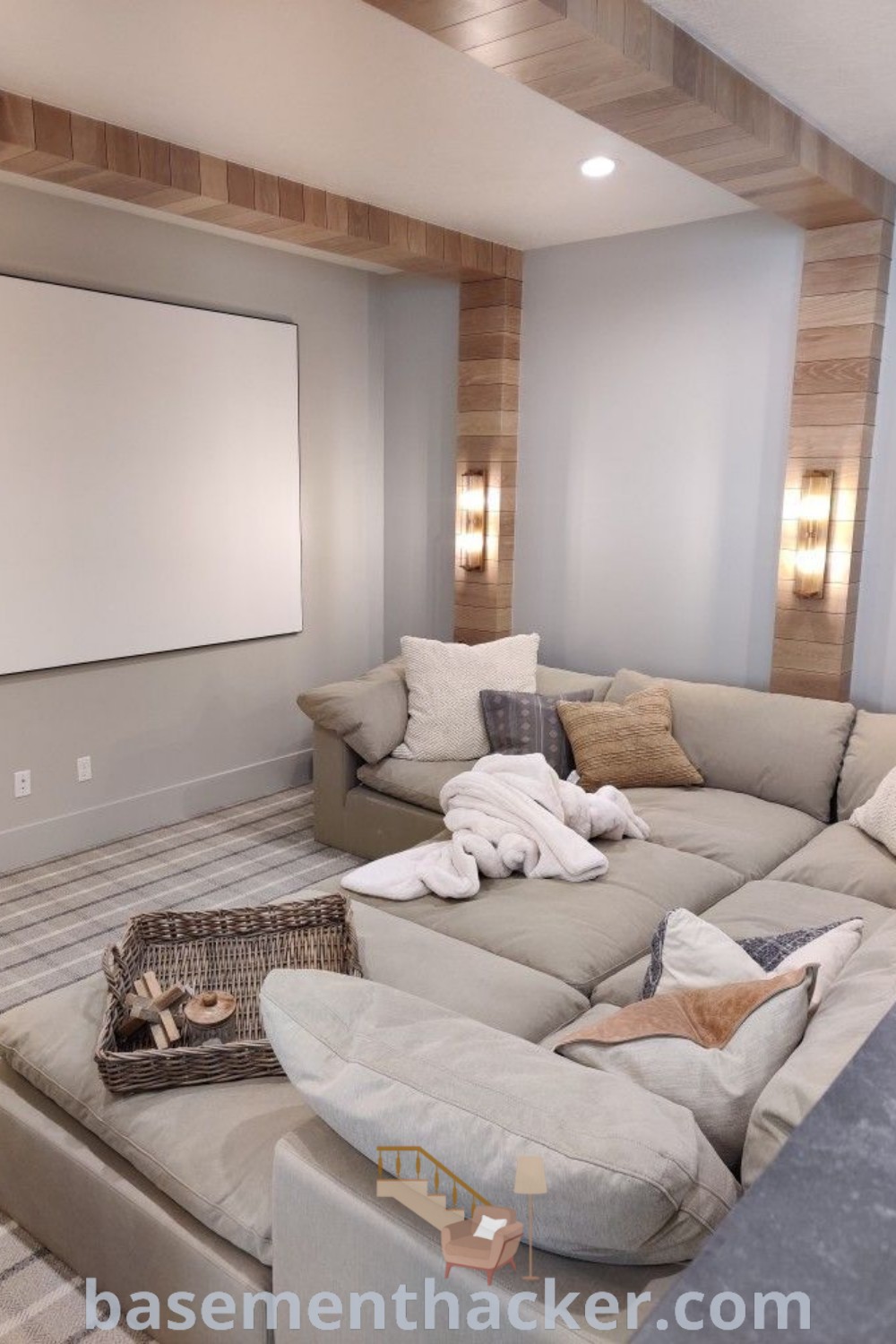 A cozy media room featuring a flat-screen TV mounted on the wall, comfortable furniture layout with a sectional, and decor inspired by media and playroom ideas. This image showcases stylish bonus room design ideas for families, providing innovative basement makeover ideas for a stunning revamp. Find more inspiration at basementhacker.com.