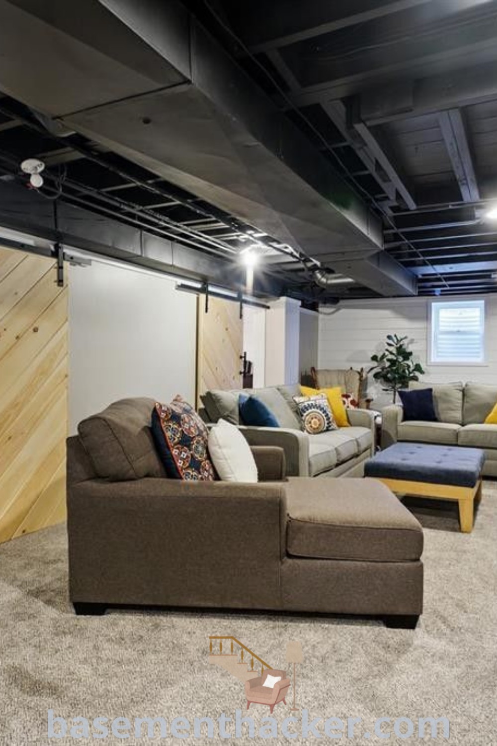 A stylish basement living room filled with inviting furniture and a flat-screen TV mounted above, showcasing innovative design ideas and finished basement layout inspirations. Ideal for ultimate entertaining and offering cozy decor options, this space provides awesome ideas for a stylish and functional home. Discover more at basementhacker.com.